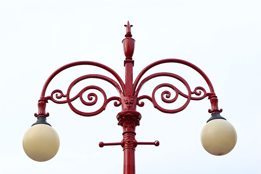 a close up shot of the top of hyde park picture house's lamp post, set against a white background