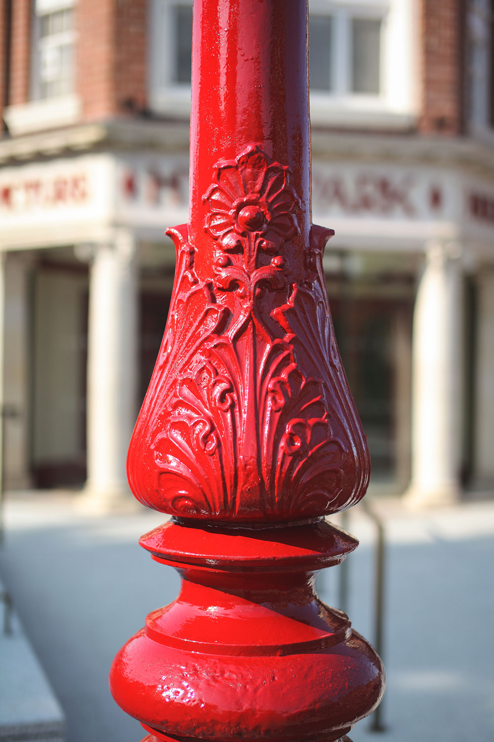 a shot of the middle portion of they hyde park picture house's lamppost, you can see the blurred outline of the cinema in the background