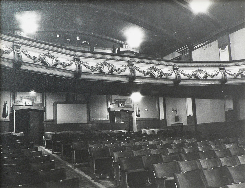 A black and white photo of HPPH's main screen. It shows both floors with the upper circle and lower circle. Empty seats sit row by row in the bottom section.