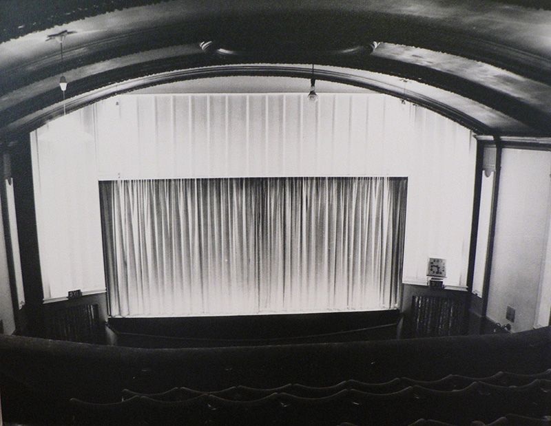 It shows the screen curtain in black and white. Long fabric covers the screen while not in use.